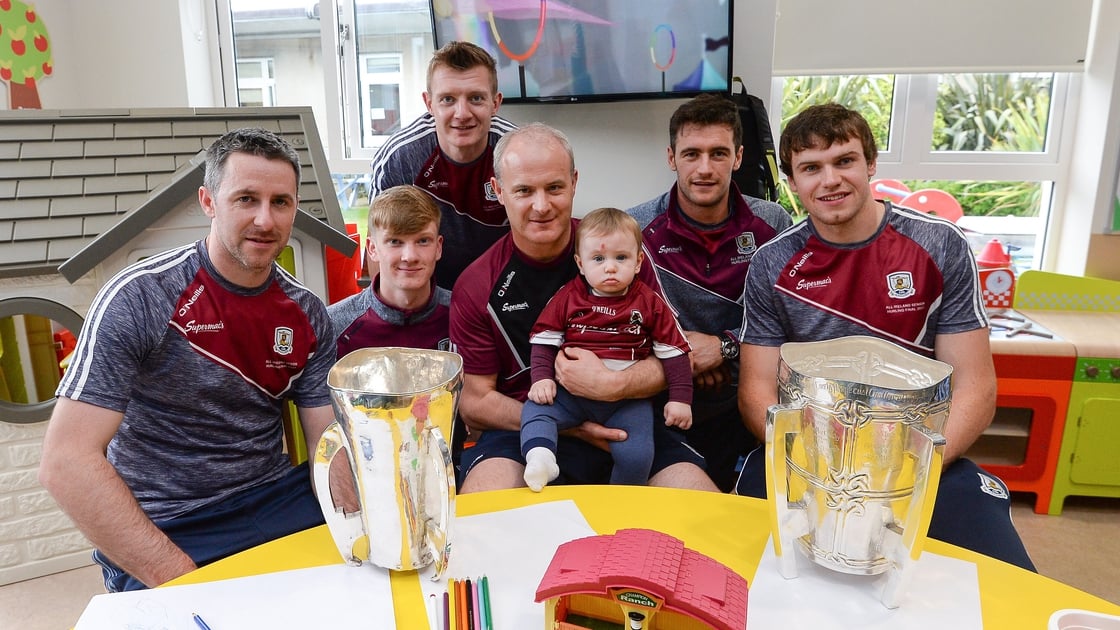 Image - Colm Callanan (L) and Joe Canning (back) with Galway's trophy haul at Crumlin Children's hospital in 2017