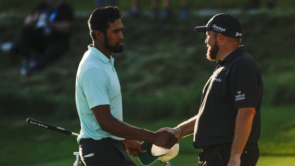 Tony Finau and Shane Lowry shake hands on the 18th green during the final round