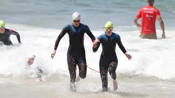 Visually impaired paratriathletes are assisted by a guide on the course (Andrew Matthews/PA)