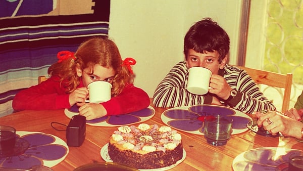 Getty Image: Vintage image of a boy and a girl drinking hot chocolate with a table