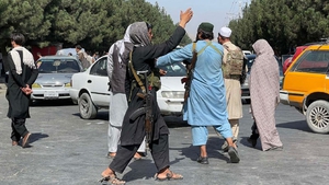 Taliban members stand guard at a checkpoint near Hamid Karzai International Airport