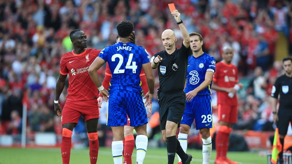Referee Anthony Taylor shows the red card and sends off Reece James