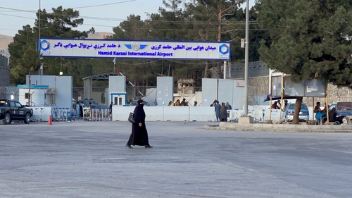 Taliban members today standing guard at a checkpoint around Hamid Karzai International Airport, the centre of evacuation efforts from Afghanistan