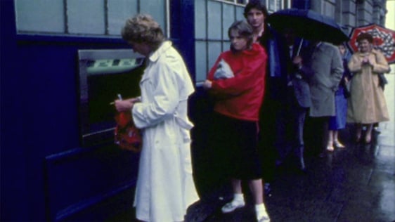 Customers queue at a Bank of Ireland ATM, 1981