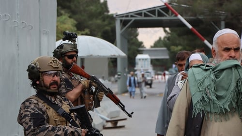 Taliban fighters stand guard outside the Hamid Karzai International Airport