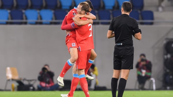 Enes Mahmutovic and Dirk Carlson of Luxembourg celebrate at full-time