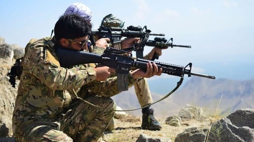 Anti-Taliban forces take positions as they patrol a hilltop in the Darband area of Panjshir province