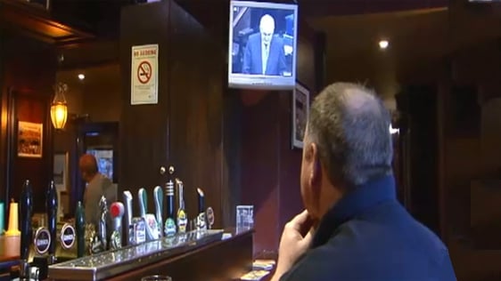 A patron of the Cat and cage pub watches Bertie Ahern's Dáil statement on TV, 2006.