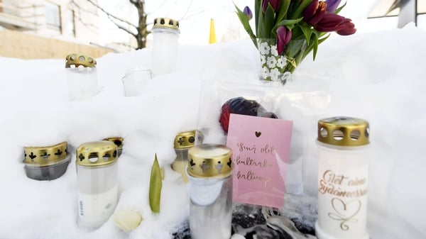 Candles, flowers and notes at the scene in Helsinki where the victim died