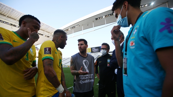 Lionel Messi (C) speaks to Brazil's Neymar Jr