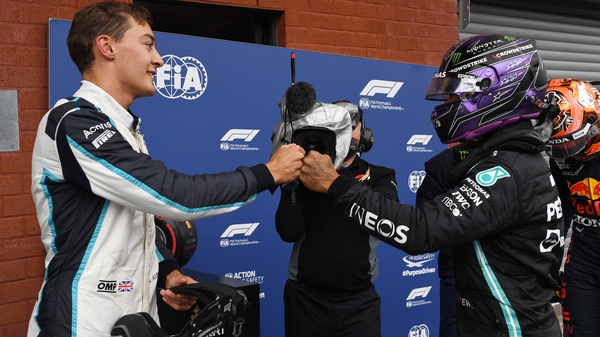 George Russell (L) and Lewis Hamilton greet each other after qualifying at the Grand Prix of Belgium last month