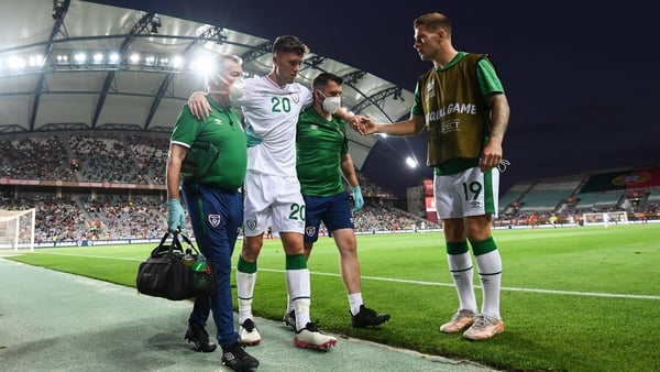 Dara O'Shea is assisted from the pitch in Faro