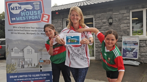 Emer Farrell with her daughters Evie and Alice after she won two tickets to Saturday's All-Ireland football final (Pic: Conor McKeown)