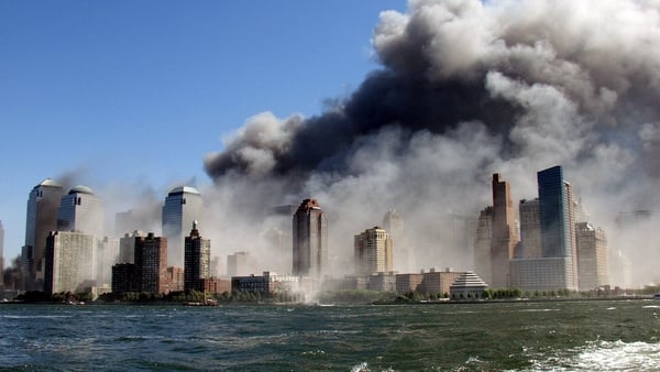 Smoke rises over the Manhattan skyline after two planes hit the Twin Towers