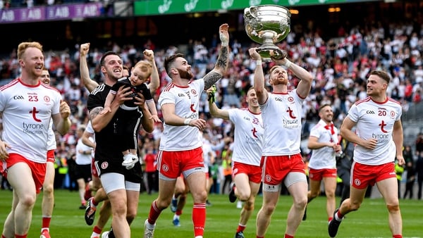 Tyrone players celebrate with the Sam Maguire