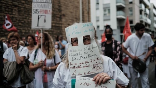 A healthcare worker demonstrates in Lyon against mandatory vaccines