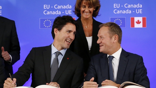 Canadian Prime Minister Justin Trudeau talks with President Donald Tusk at the signing ceremony of CETA in 2016