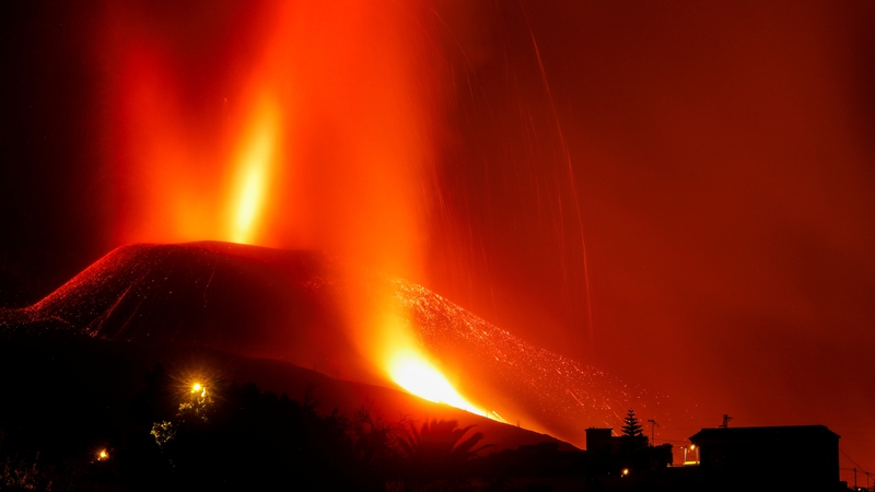 Lava and smoke rise from the Cumbre Vieja volcano on La Palma
