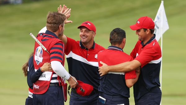 Bryson DeChambeau, Collin Morikawa and Scottie Scheffler celebrate victory