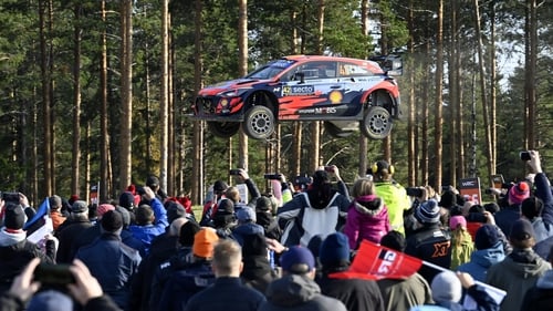 Spectators watch as the Hyundai of Irish driver Craig Breen and his Irish co-driver Paul Nagle soar through the air in Finland