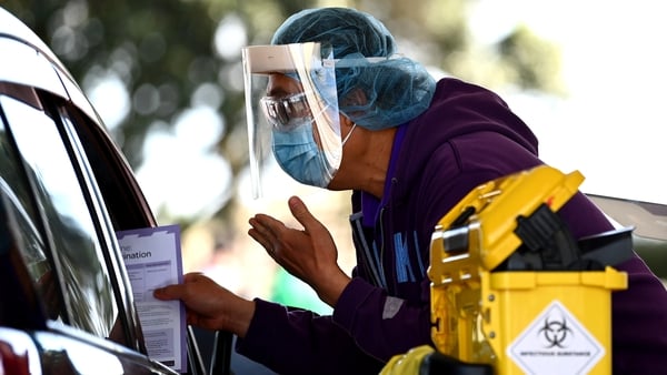 A nurse hands out information after vaccinating a member of the public in their car 
in New Zealand (File image)