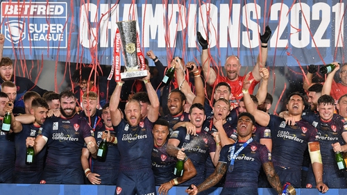 St Helens captain James Roby lifts the Super League trophy