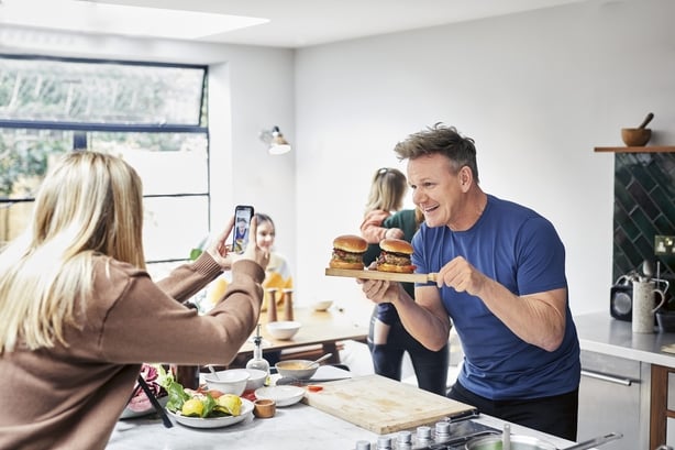 Gordon Ramsay being filmed in the kitchen by his kids