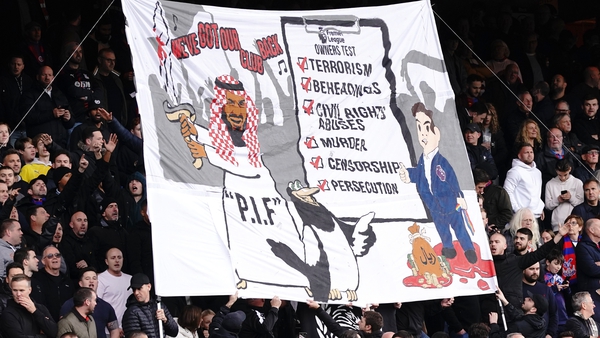 The banner listed human rights abuses but also pictured a person wearing Arab-style clothing and holding a bloody sword