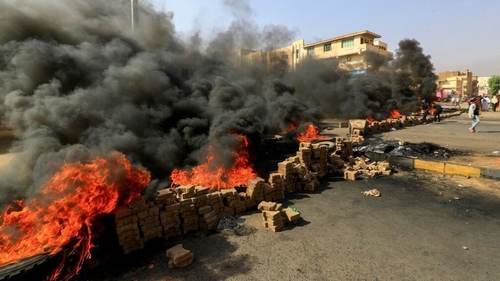 Protesters use bricks and burning tyres in the capital Khartoum to denounce the action