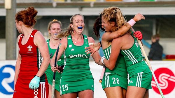 Sarah Hawkshaw, centre, and Zara Malseed congratulate Anna O'Flanagan after her second goal against Wales