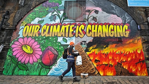 A climate change mural near the COP26 summit venue in Glasgow. Photo: Jeff J Mitchell/ Getty Images