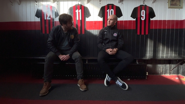 Bohemians player Georgie Kelly and climate justice officer Seán McCabe chatting in the dressing room at Dalymount Park