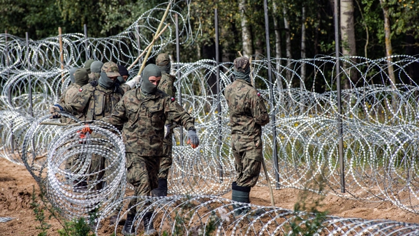 Polish soldiers are seen building a razor wire fence along the border with Belarus
