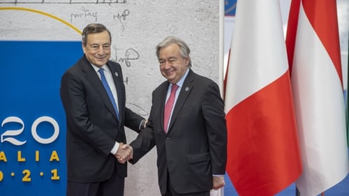 United Nations Secretary-General Antonio Guterres (R) is welcomed by Italian Prime Minister Mario Draghi