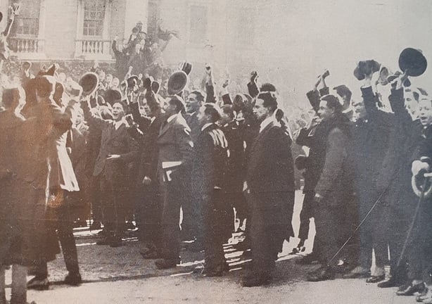 Trinity College students cheering after singing 'God Save the King' in College Green in Dublin. Photo: Irish Life, 18 November 1921. Full collection available at the National Library of Ireland.