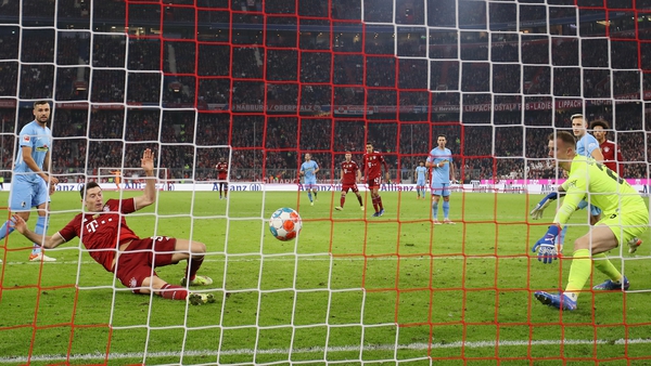 Robert Lewandowski of FC Bayern Muenchen scores their team's second goal