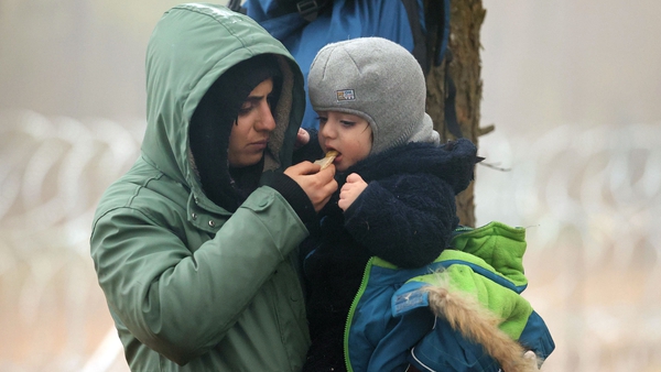 Thousands of men, women and children are huddled in freezing conditions at the Belarus-Poland border