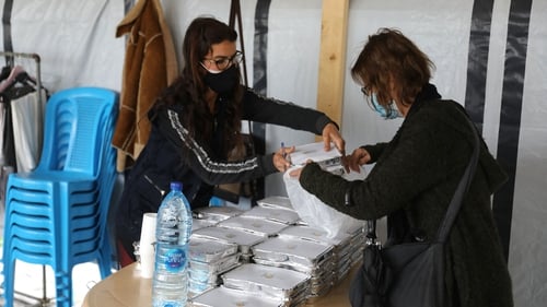 People collect supplies from a food bank in Lebanon