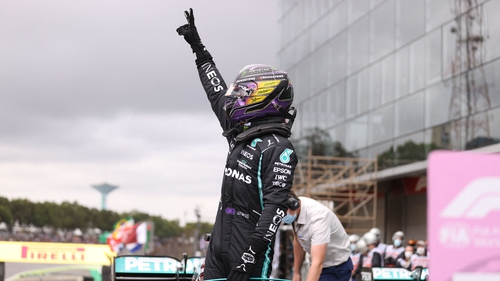 Hamilton celebrates after winning the qualifying session