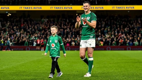 Johnny Sexton takes the applause of the crowd with his son Luca after the full-time whistle
