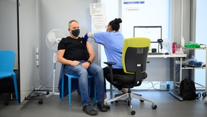 A man receives a Covid-19 booster jab at the Sir Ludwig Guttmann Health & Wellbeing Centre in Stratford