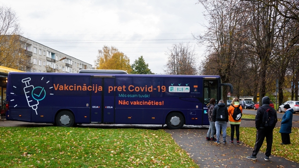 People stand in line to get a jab in a Covid-19 vaccination bus is seen in Riga last month