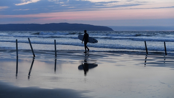 A young surfer heads home from a day's surfing at Castlerock Beach, Co Derry. Photo: Michael Cooper/Getty Images
