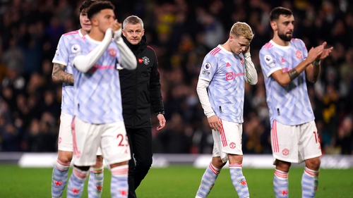 Dejected Manchester United players acknowledge the travelling fans after the full-time whistle as manager Ole Gunnar Solskjaer looks on