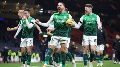 Martin Boyle celebrates with his Hibernian team-mates and the match ball following the victory over Rangers