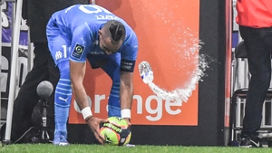 Marseille's French midfielder Dimitri Payet is hit by a bottle of water