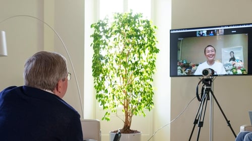 A photo made available by the International Olympic Committee (IOC) website shows IOC President Thomas Bach holding a video call with Chinese tennis star Peng Shuai on Sunday