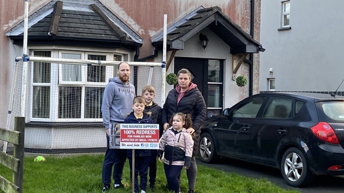 Joanne and Denis Taitt with their children outside their mica damaged home