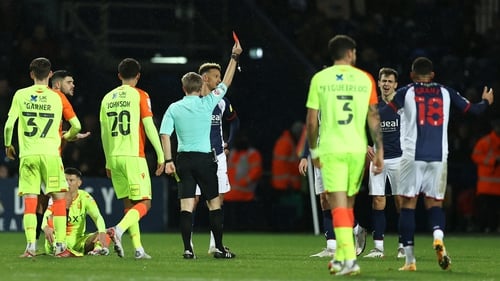 Referee Gavin Ward shows Jayson Molumby the red card
