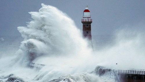 Waves crash the against the sea wall and Roker Lighthouse in Sunderland in the tail end of Storm Arwen